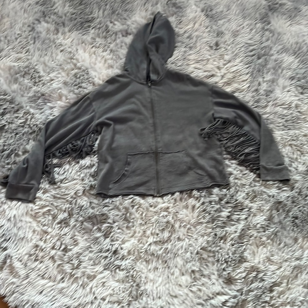 This gray sweatshirt includes tassels on the arms Pockets in a hood!